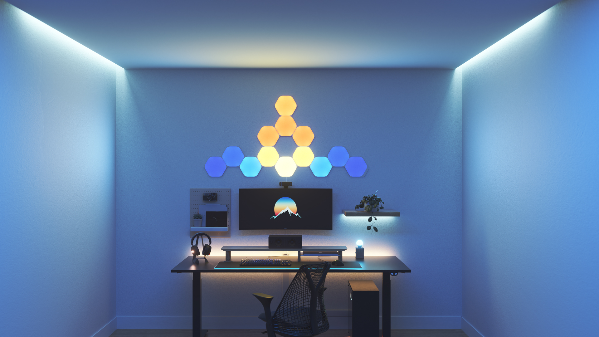 Kawaii style gaming setup with Nanoleaf Shapes Hexagon smart home RGB light panels above the PC monitor. The perfect smart lights to complete the gamer aesthetic.