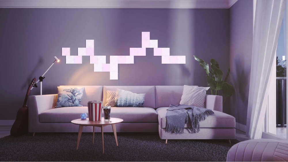 Esta es una imagen de una sala de estar moderna y tranquila con cuadrados de luz Nanoleaf Canvas detrás del sofá. Los paneles RGB que cambian de color tienen más de 16 millones de colores vibrantes y brillantes y son completamente personalizables gracias a su diseño modular. Las luces de sala de estar perfectas para crear el ambiente.
