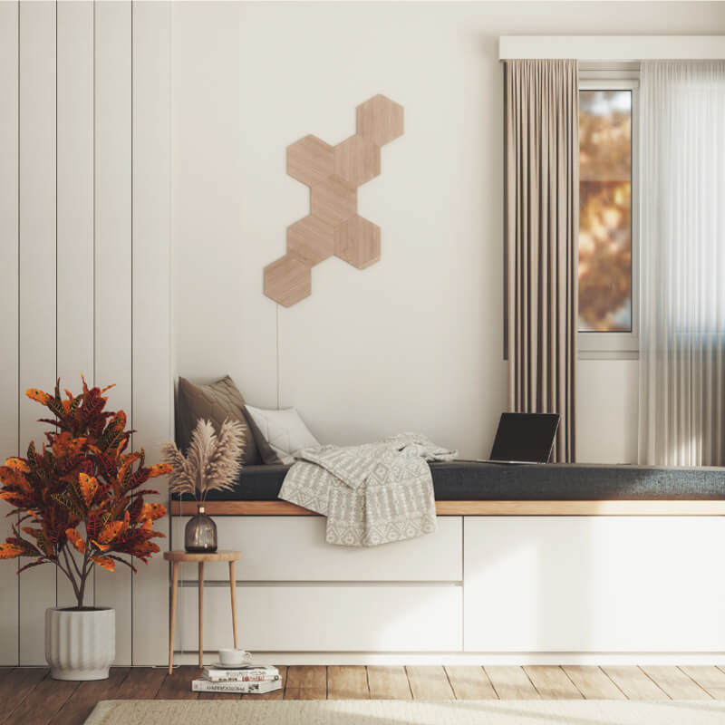 Nanoleaf Elements Thread enabled wood look hexagon smart modular light panels mounted to a wall above a cozy nook. HomeKit, Google Assistant, Amazon Alexa, IFTTT.