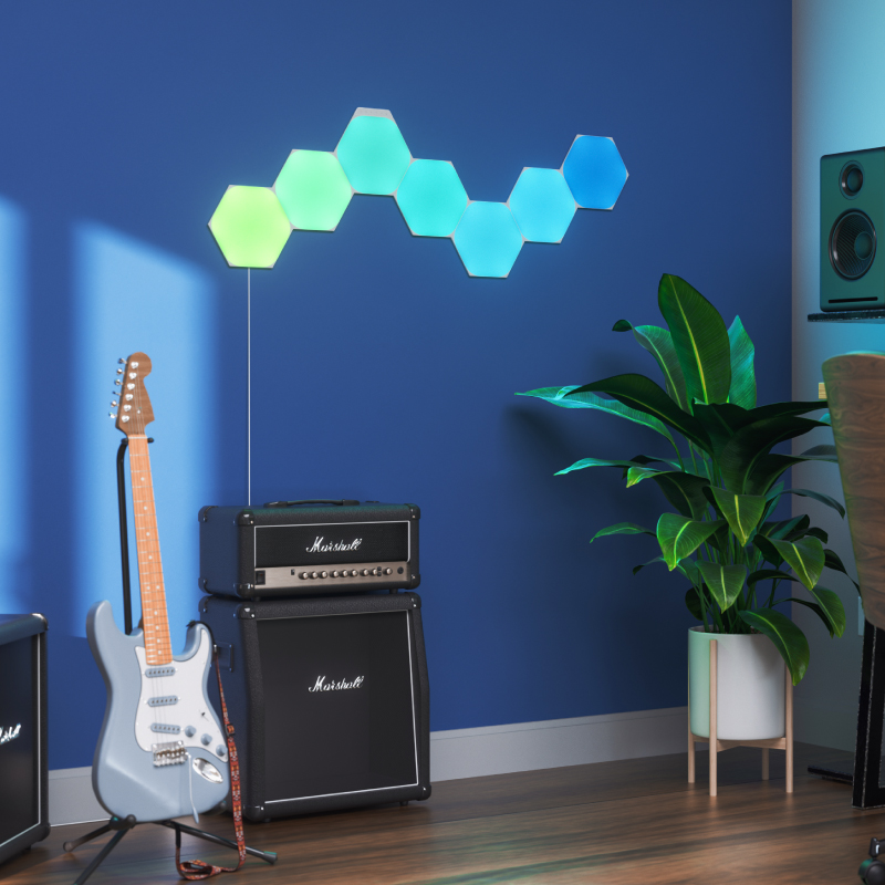 Painéis de luz inteligente Nanoleaf Shapes modulares hexagonais com mudança de cor e ativados por Thread, montados na parede de uma sala de música. Semelhante ao Philips Hue, Lifx. HomeKit, Google Assistant, Amazon Alexa, IFTTT. 
